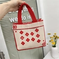Detail of red and white knit tote bag featuring woven heart and smiley face symbols - Red White Symbols