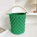 Detail of green bubble knit bucket bag featuring elegant white pearl bead handle and texture - 20cm x 20cm x 15cm / Dark Green