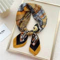 Elegant geometric printed silk scarf in yellow and black, folded in a display tray - Geometric Frame Yellow