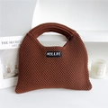 Detailed knit texture of a brown dumpling tote bag with branding on a minimalist white stage - Brown