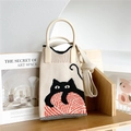 Close-up of knit tote bag with black cat and red yarn pattern on a wooden shelf - Beige Cat