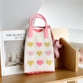 Detail of white knitted crossbody bag with colorful hearts and pink handles - Beige Heart