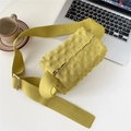 Detailed close-up of mustard yellow knitted crossbody bag with waffle texture and wide strap - Yellow