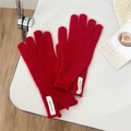 Detalle de guantes de punto rojos con textura de lana suave y etiqueta blanca tejida - Talla única / Rojo