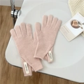 Detail of light pink knitted gloves with woven label on soft wool material - One Size / Light Pink