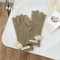 Detail of olive green knit gloves featuring beige pom-poms and brand labels for winter - One Size / Bean Green