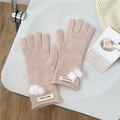 Detail of pink knitted gloves with soft white pom poms and elegant brand label - One Size / Light Pink