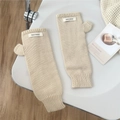 Detalle de guantes de punto crema sin dedos con agujero para el pulgar y puños elásticos - Blanco Roto