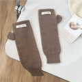 Detailed close-up of brown knit fingerless arm warmers with a white 'JENNIE WOOL' label - One Size / Knit Patch Style / Brown