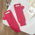 Close-up of rose pink chunky knit fingerless gloves with thumb hole and woven label - One Size / Knit Patch Style / Hot Pink