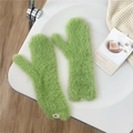 Detailed texture of grass green plush mittens featuring a woven brand label for winter - Emerald Green