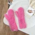 Close-up of pink plush mittens with warm thick fur texture and white brand woven label - Rose Red