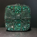 Detailed view of luxury square clutch with emerald green crystals and 3D rhinestone bow - Emerald