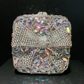 Macro detail of luxury evening clutch with sparkling crystals and bow pattern design - Silver AB