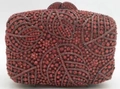 Detailed view of the leaf-patterned crystal evening clutch in deep red rhinestone finish - Red