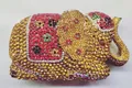 Detailed view of the 3D elephant evening bag with red and gold crystals and floral accents - Gold Multicolor