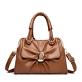 Caramel brown handbag with bow-tie pleats, golden metal buckle and crossbody strap - Brown