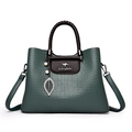 Borsa verde scuro goffrata con manico intrecciato marrone e ciondolo a foglia e perla - Verde
