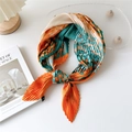 Pleated square scarf in orange, emerald green, and beige tied as a stylish necktie - Orange Cyan Small Leaves