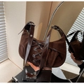 Detail of dark brown suede crescent bag featuring lace-up design and silver hardware - Coffee