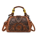 Retro brown leather handbag with embossed floral patterns and a bamboo handle on white back - Yellow Brown