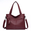Large burgundy pebble grain leather tote bag with crossbody strap and sturdy handles - Red