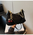 Detail of black suede crescent bag with golden chain and a cute red cherry charm detail - With Charm / Black