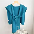 Detailed view of 100% wool teal knitted shawl texture on a wooden hanger with soft fabric - 46x115cm / Cyan Blue