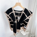 Detail of striped knitted shawl with knotted front and premium ribbed edge textures - Black with Beige Stripes