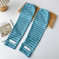 Detail of blue striped knitted arm sleeves with white woven label on ribbed fabric - One Size / Blue Purple Stripe