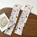 Close-up of pink cooling arm sleeves with star and heart patterns on wooden tray - One Size