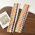 Detailed view of checkered sun protection sleeves in orange and purple ice silk fabric - One Size