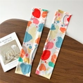 Detail view of white sun sleeves with colorful heart patterns and knit edge stitching - One Size