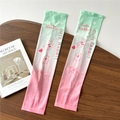 Detail of gradient ice silk sun sleeves with cute rabbit print on a textured wooden table - One Size