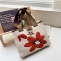 Close-up of beige knitted flower tote bag featuring thick texture and magnetic button closure - 22*28cm / Orange Tri-Color Flower