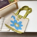 Close-up of floral knitted tote bag featuring a green strap and button closure detail - 22*28cm / Blue with Three-Color Flowers