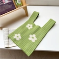 Detail of green knitted tote bag with white floral patterns in a cozy indoor setting - Pastoral White Flower / Grass Green