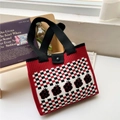 Close-up of knit tote bag with red and black checkerboard and strawberry jacquard pattern - Red Checkerboard Flower