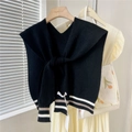 Detailed knit texture of a black V-neck shawl with retro stripe accents on a wooden hanger - Black Two-tone Stripes