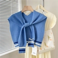 Detail of blue knitted shawl with striped cuffs and tie-knot design over a beige dress - Blue Two-tone Stripes