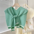 Detail of mint green knitted shawl featuring striped hem and V-neck tie closure - Green Two-tone Stripes