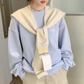 Close-up detail of cream knit shawl knotted over a light blue sweatshirt for styling - Beige Two-tone Stripes