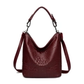Deep red crocodile embossed bucket bag with sturdy top handles and adjustable straps - Burgundy