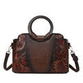 Brown leather handbag featuring vintage embossed sunflower patterns and round handles - Brown