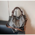 Detail of vintage tote bag with metal ring, brown handles, and wide shoulder strap - Black