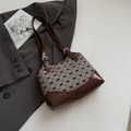 Vintage shoulder bag featuring brown leather patchwork and black bow pattern accents - Coffee without Pendant