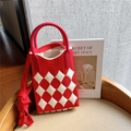 Close-up of red and white knit phone bag with plaid texture on a minimalist chair - Red Rice Diamond Lattice