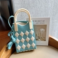 Close-up of light blue and beige checkered knit crossbody bag on a wooden chair - Blue & Beige Argyle