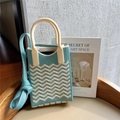 Close-up of wavy knit texture and cream top handle on blue crossbody phone bag - Blue & Beige Wave