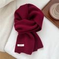 Detail of burgundy 100% wool scarf showing high-quality knit texture and white label - Ancorra Red